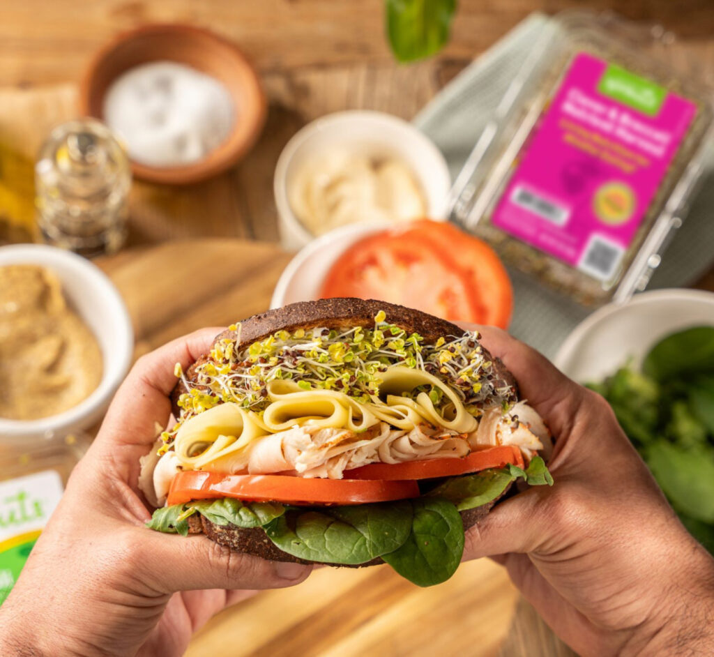 Eating a Sprout Sandwich in the kitchen